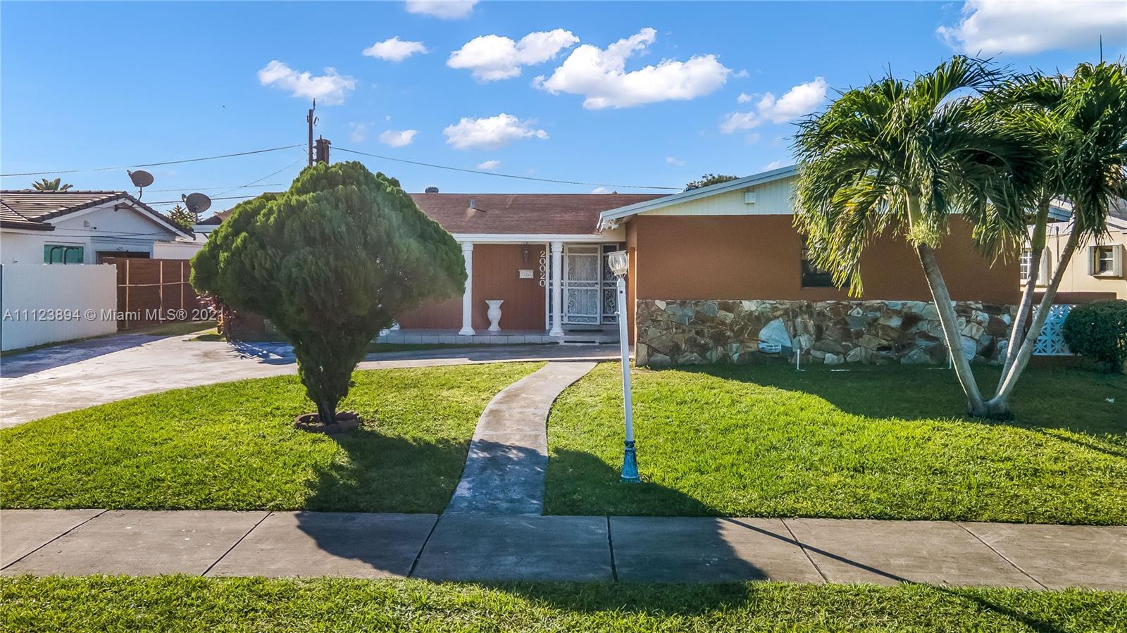 20020 Southwest 112th Avenue Miami, FL 33189 - Photo 3 of 39 a front view of a house with garden