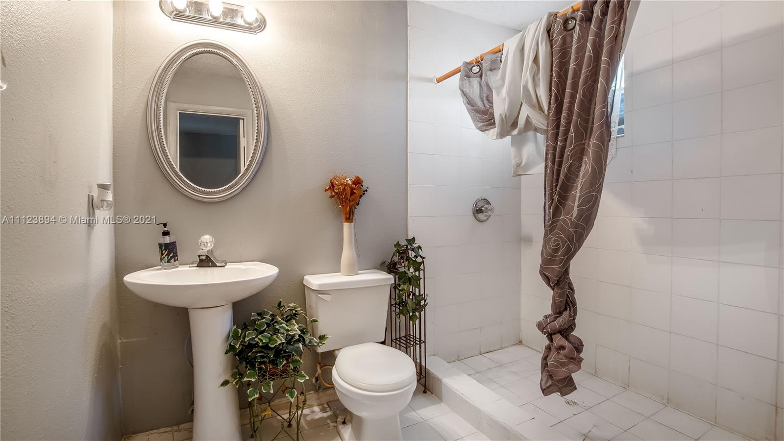 20020 Southwest 112th Avenue Miami, FL 33189 - Photo 22 of 39 a bathroom with a sink mirror and toilet