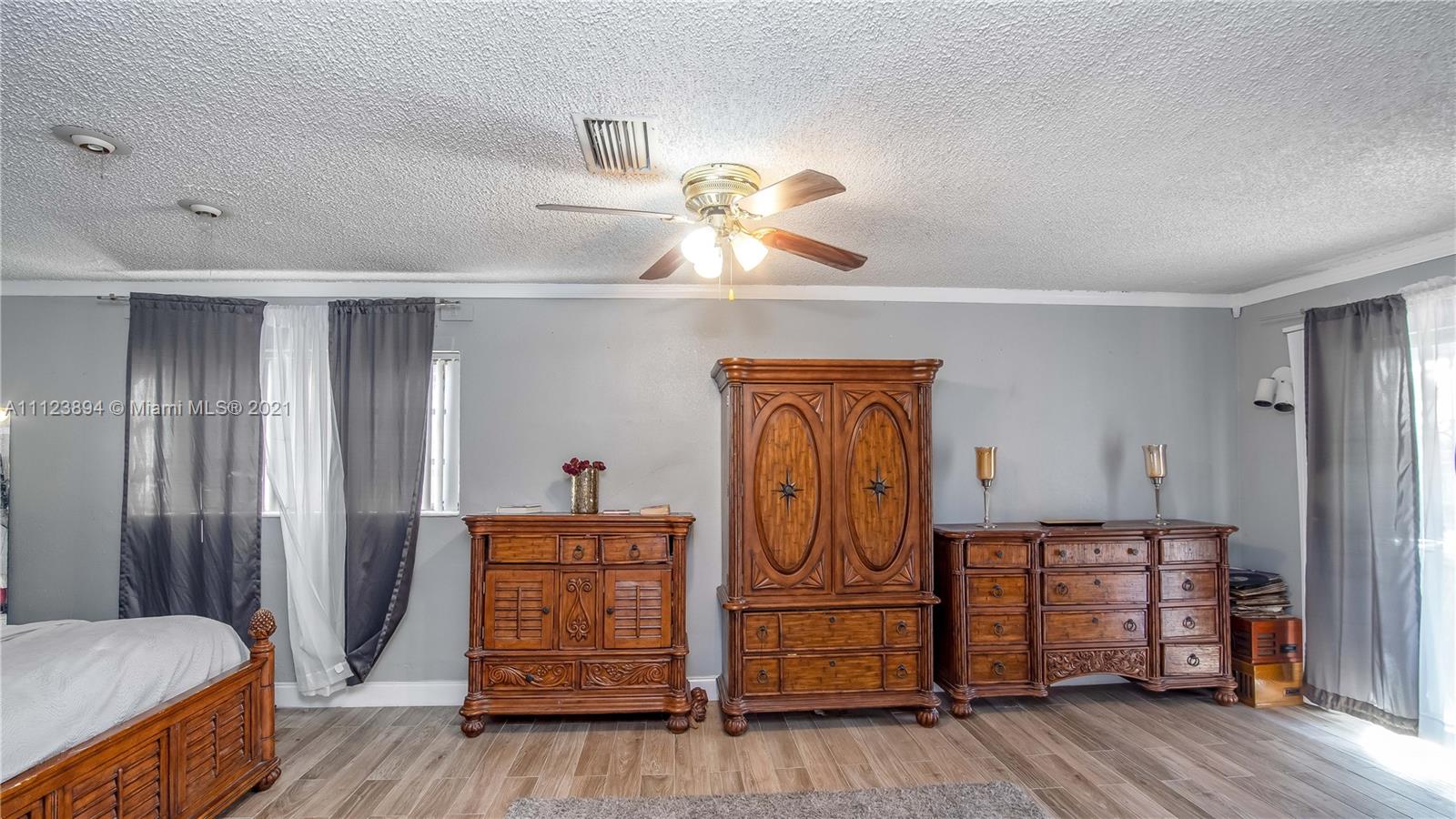 20020 Southwest 112th Avenue Miami, FL 33189 - Photo 25 of 39 a bedroom with furniture and wooden floor