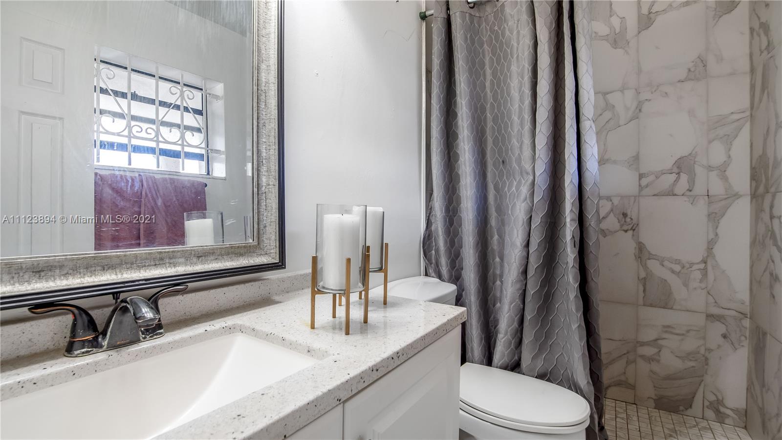 20020 Southwest 112th Avenue Miami, FL 33189 - Photo 29 of 39 a bathroom with a granite countertop sink toilet and mirror