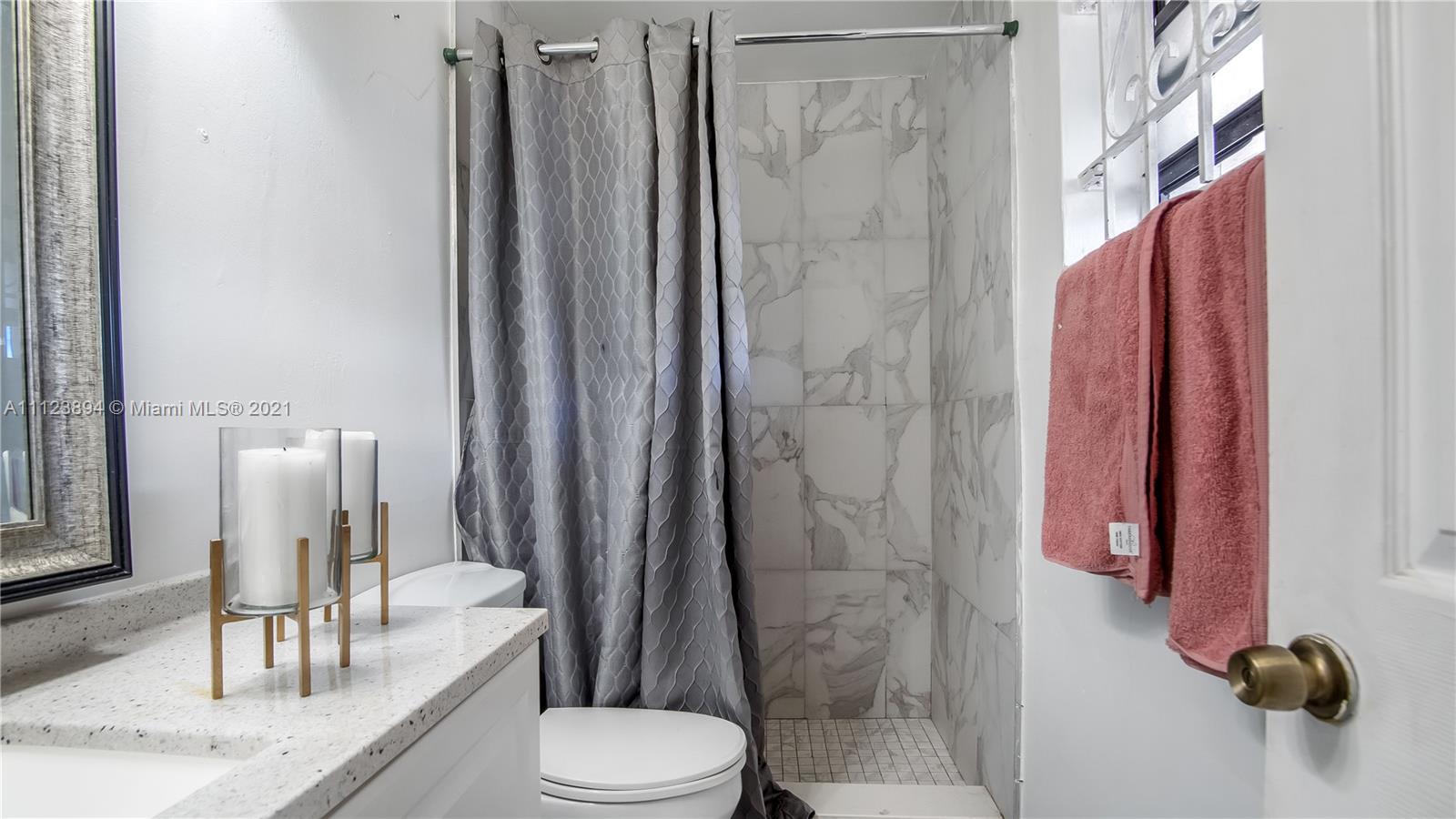20020 Southwest 112th Avenue Miami, FL 33189 - Photo 30 of 39 a bathroom with a granite countertop shower a toilet and a sink
