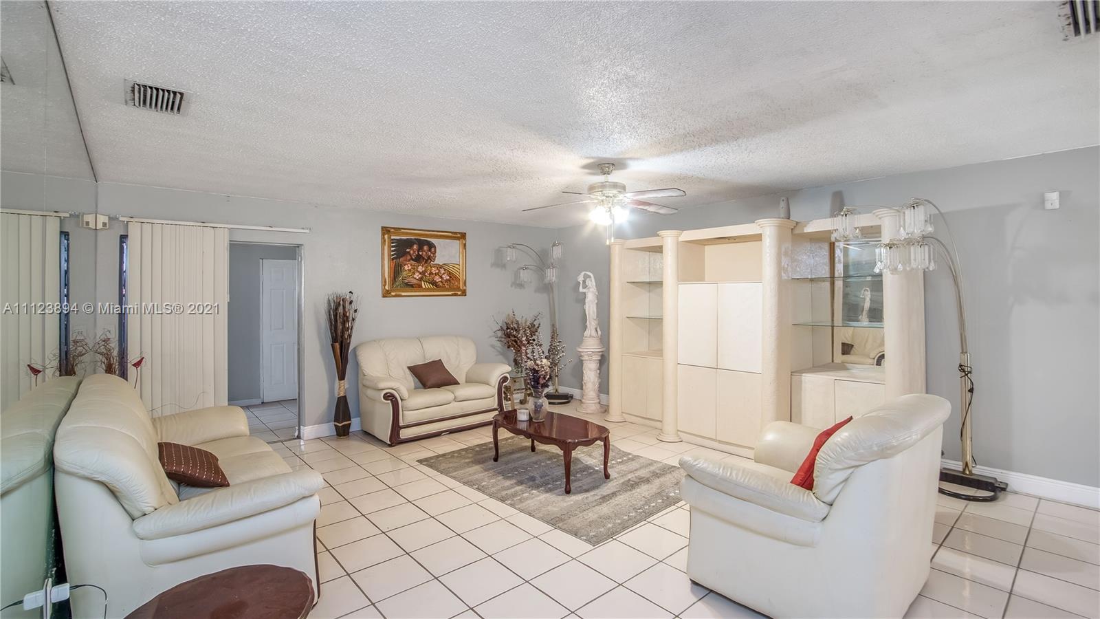 20020 Southwest 112th Avenue Miami, FL 33189 - Photo 4 of 39 a living room with furniture and a large window
