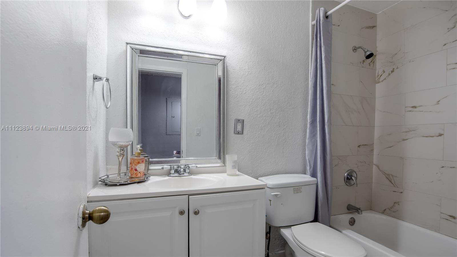 20020 Southwest 112th Avenue Miami, FL 33189 - Photo 33 of 39 a bathroom with a sink a toilet and shower