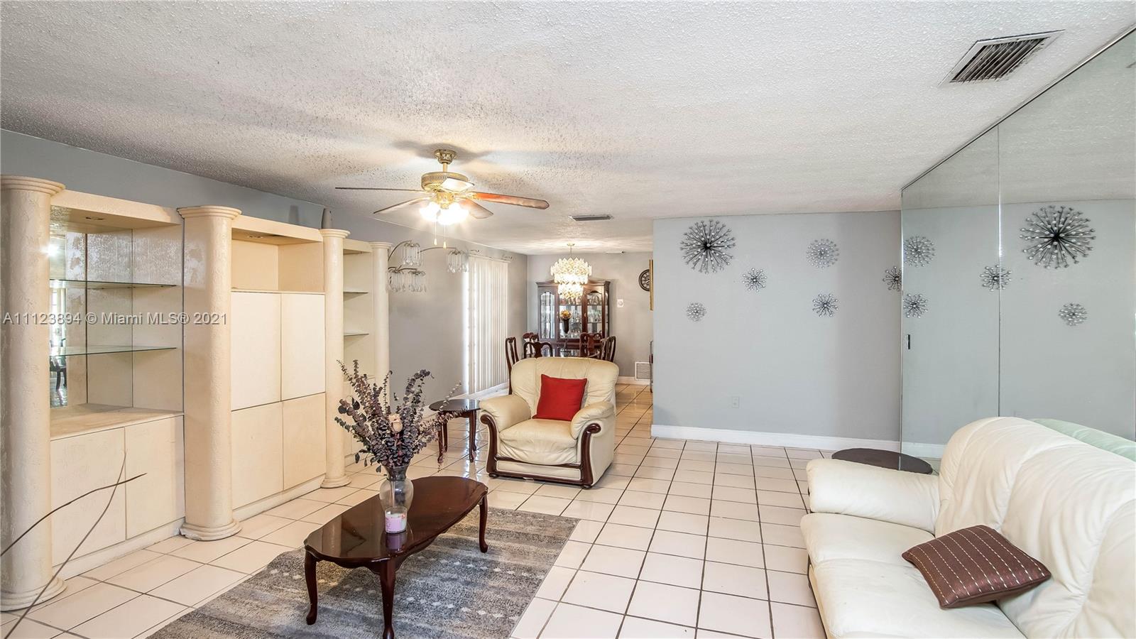 20020 Southwest 112th Avenue Miami, FL 33189 - Photo 7 of 39 a living room with furniture and a rug