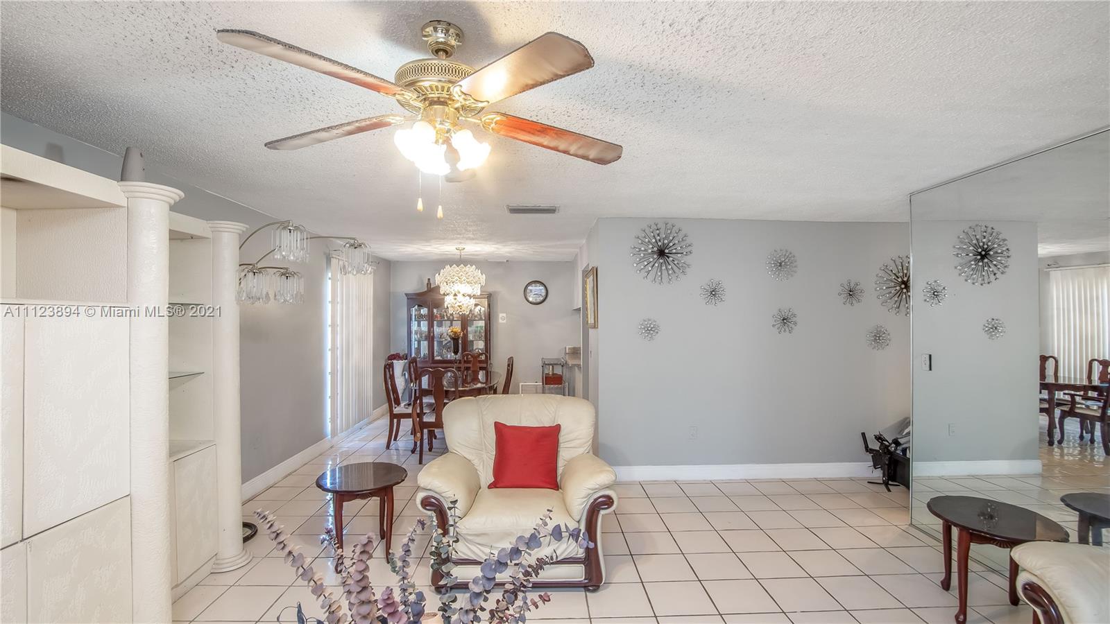 20020 Southwest 112th Avenue Miami, FL 33189 - Photo 8 of 39 a living room with furniture and a chandelier
