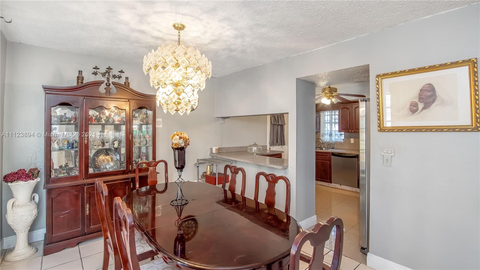 20020 Southwest 112th Avenue Miami, FL 33189 - Photo 10 of 39 a view of a dining room with furniture a chandelier and a chandelier