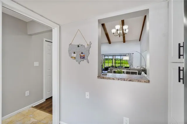 a view of hall way with mirror and window