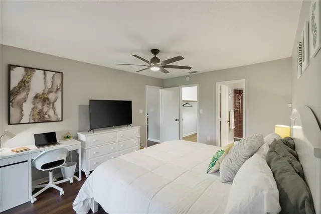 a bedroom with a bed window and a desk