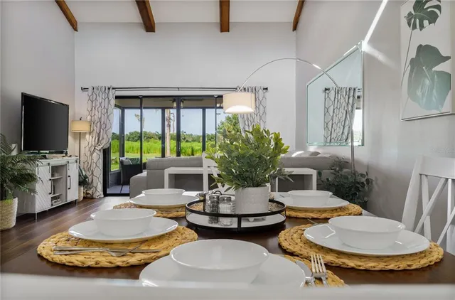 a living room with furniture a lamp and a flat screen tv