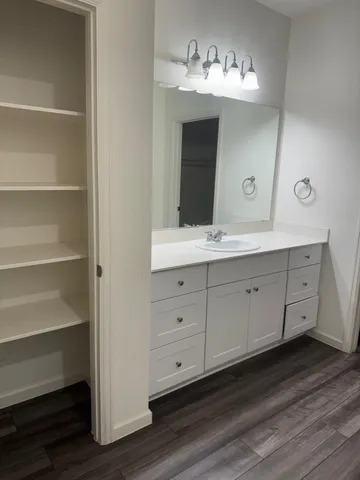 a bathroom with a double vanity sink and a mirror