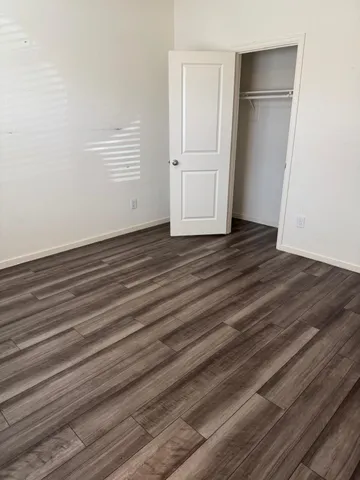 a view of a room with wooden floor
