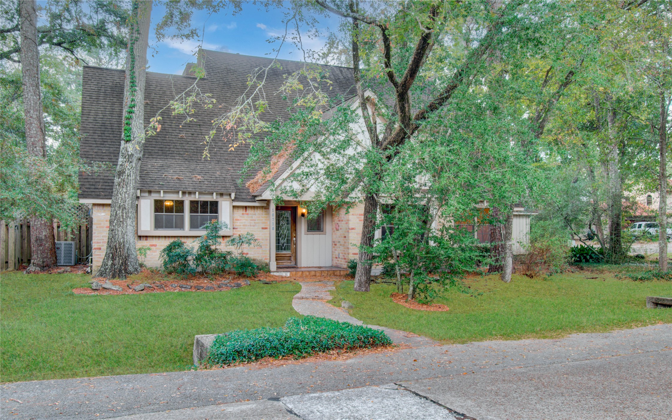 10715 East Timberwagon Circle Spring, TX 77380 - Photo 2 of 50 a front view of a house with a garden and yard