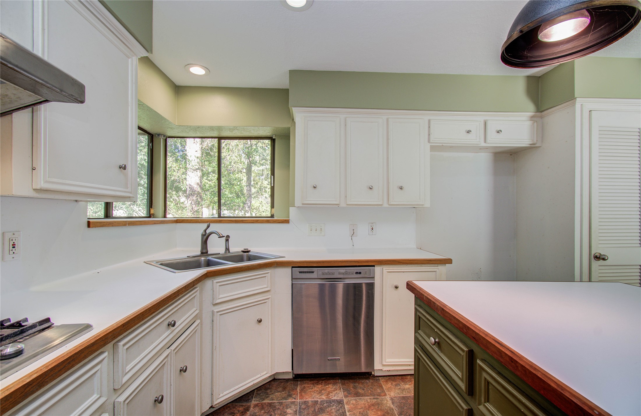 10715 East Timberwagon Circle Spring, TX 77380 - Photo 22 of 50 a kitchen with a sink a stove and cabinets