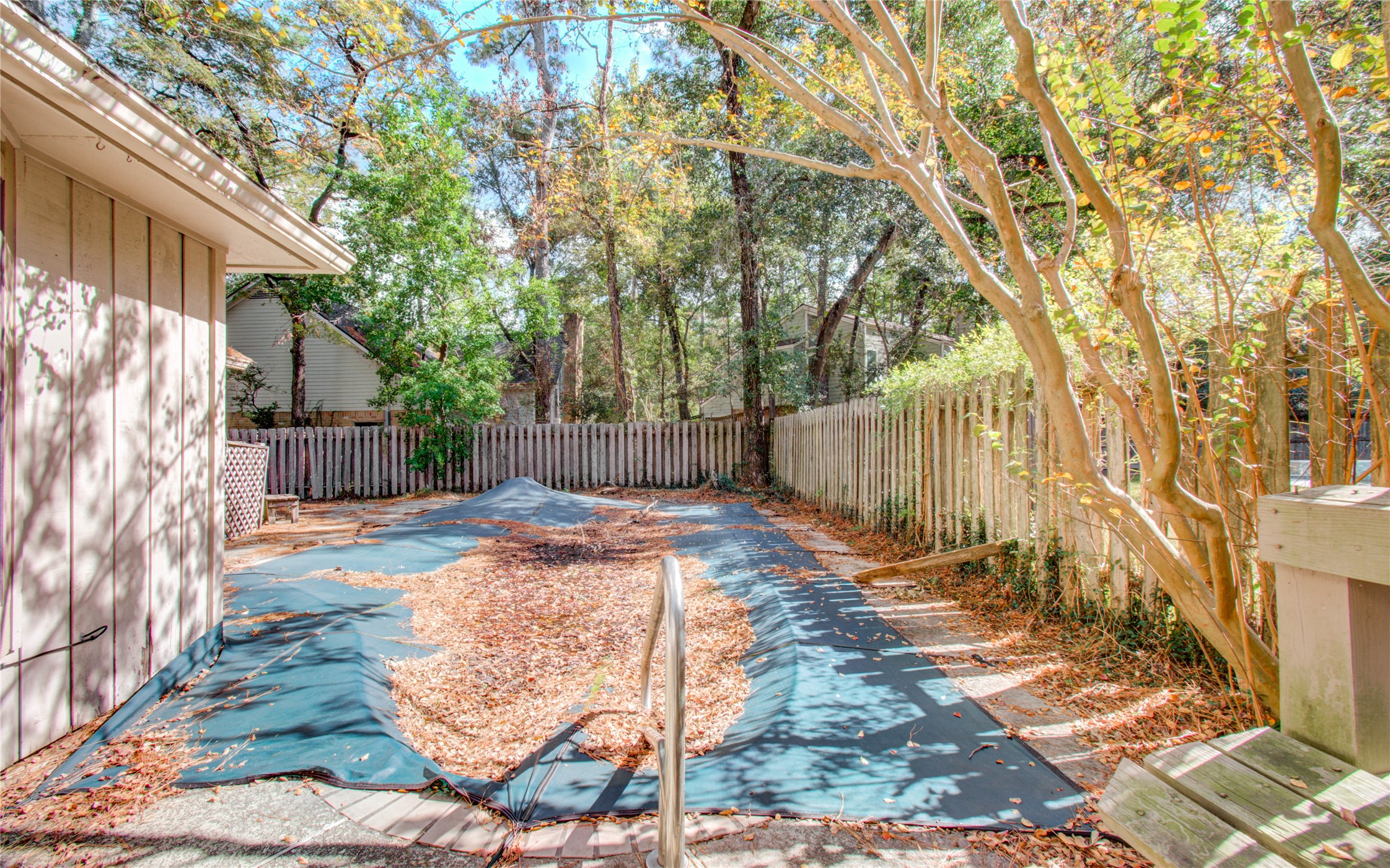 10715 East Timberwagon Circle Spring, TX 77380 - Photo 47 of 50 a view of a backyard with wooden fence and large trees