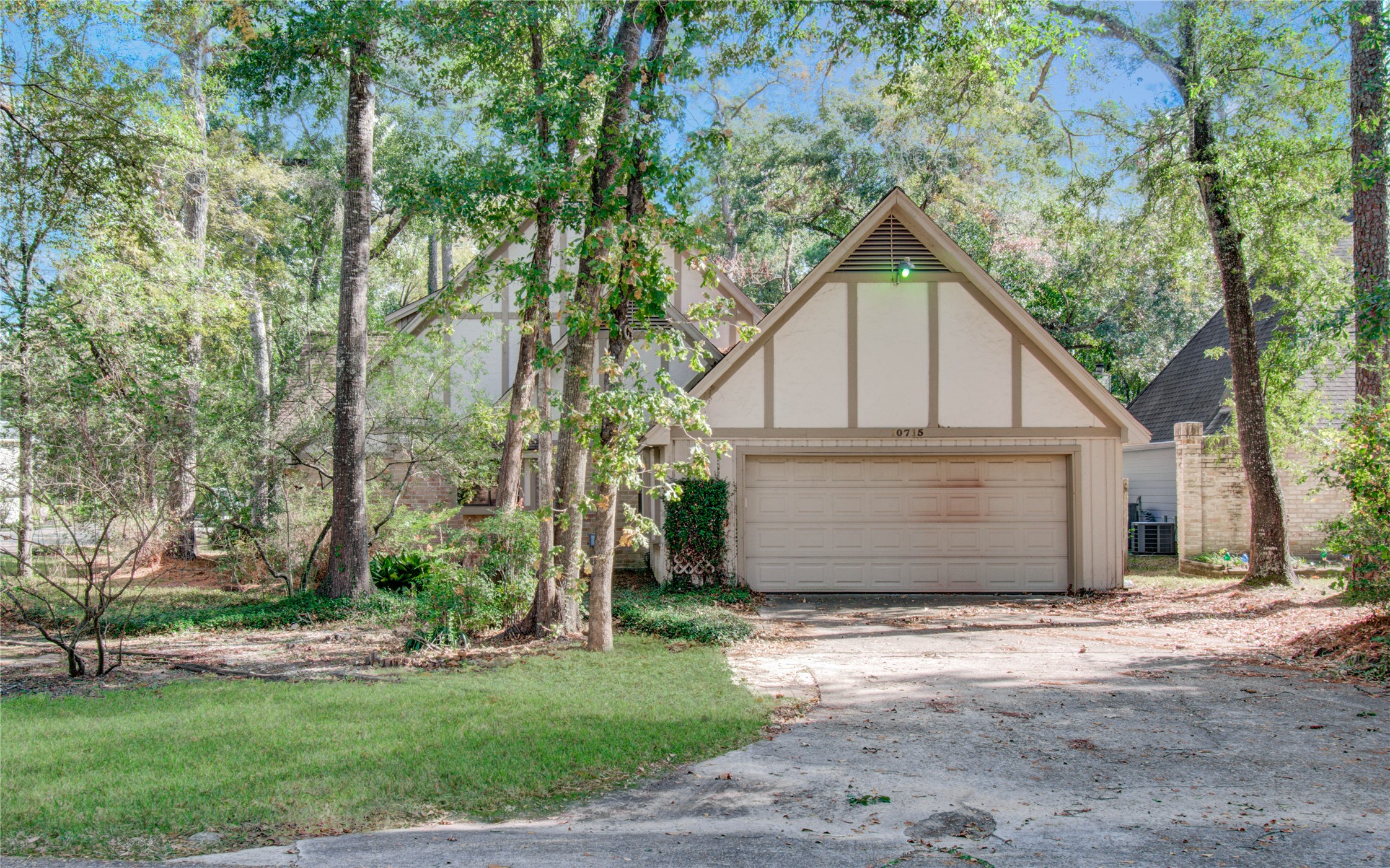 10715 East Timberwagon Circle Spring, TX 77380 - Photo 6 of 50 a view of a house with a yard and large tree