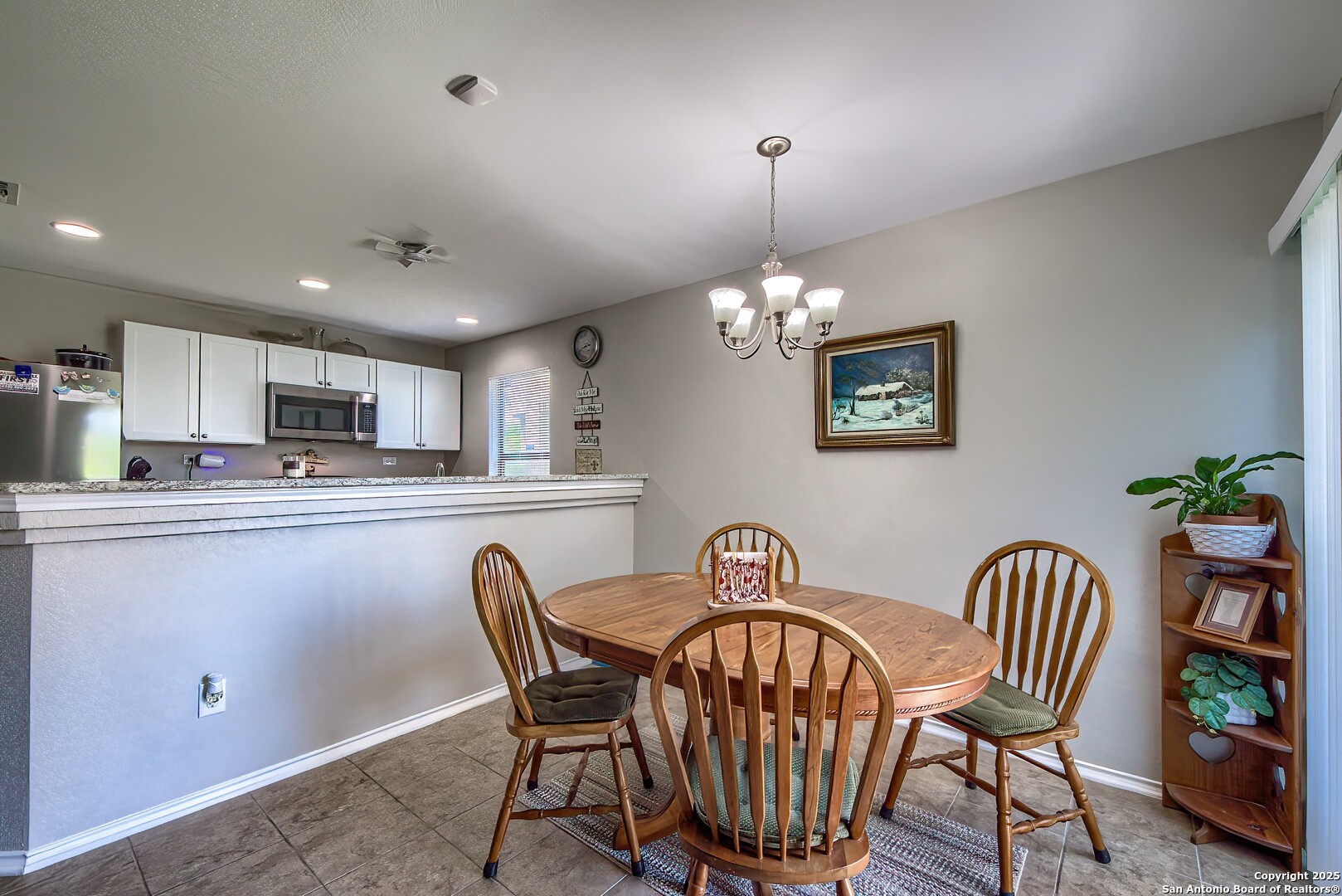 5709 Ping Way Cibolo, TX 78108 - Photo 12 of 28 a dining room with furniture and chandelier