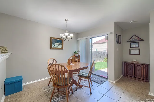 a dining room with furniture a chandelier and wooden floor
