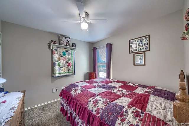 a bed sitting in a bedroom next to a window