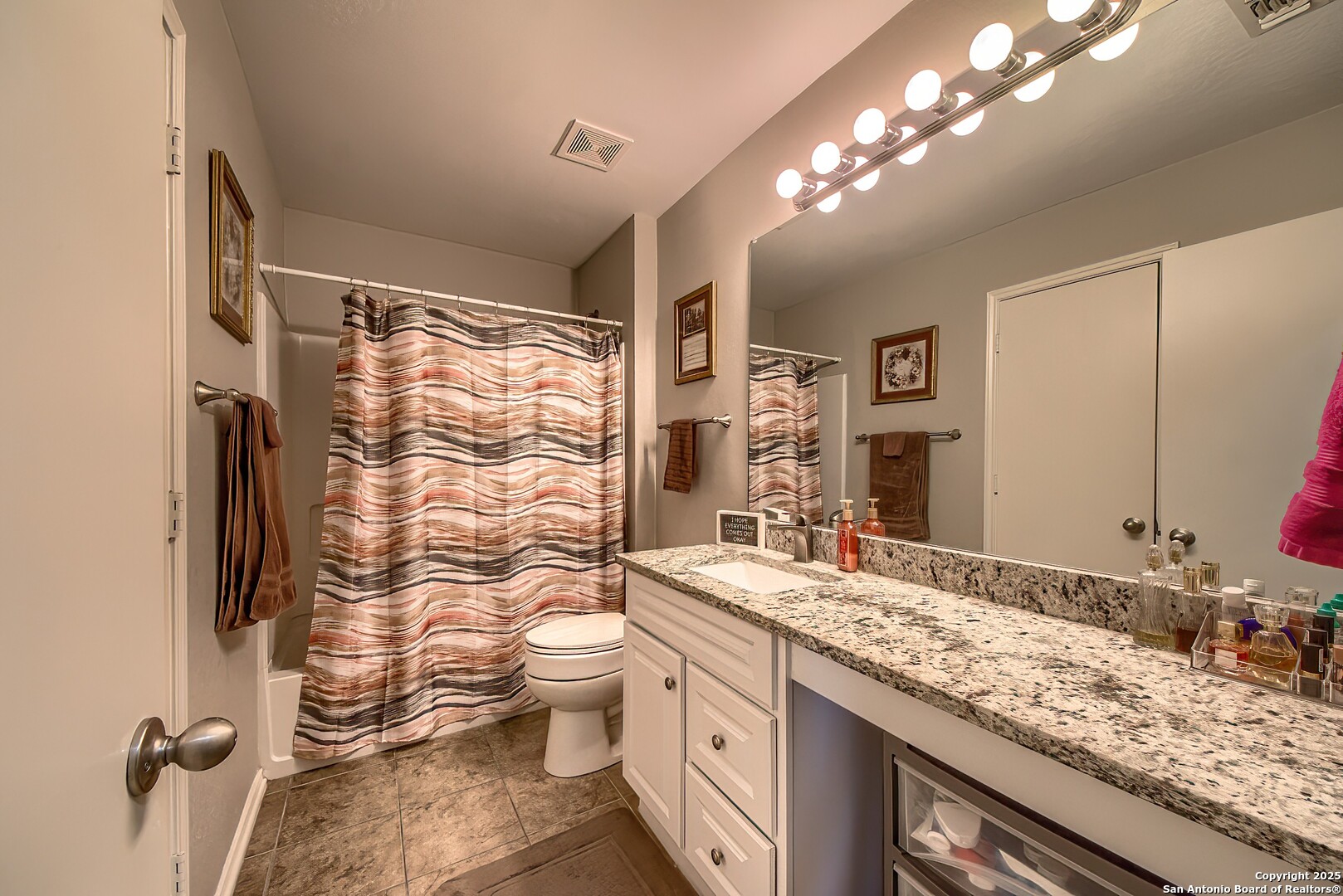 5709 Ping Way Cibolo, TX 78108 - Photo 19 of 28 a bathroom with a granite countertop double vanity sink toilet and shower