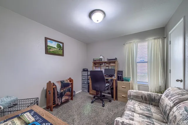 a view of workspace with furniture and wooden floor