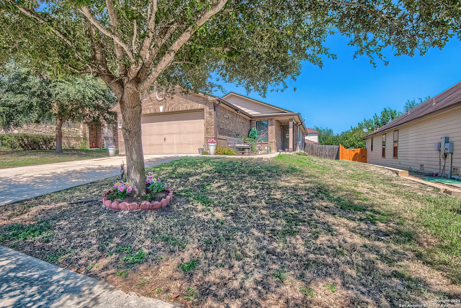 5709 Ping Way Cibolo, TX 78108 - Photo 2 of 28 a backyard of a house with flower plants