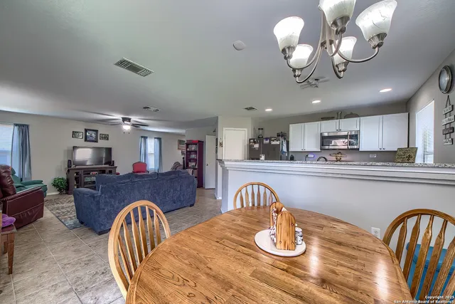 a living room with furniture kitchen view and a dining table