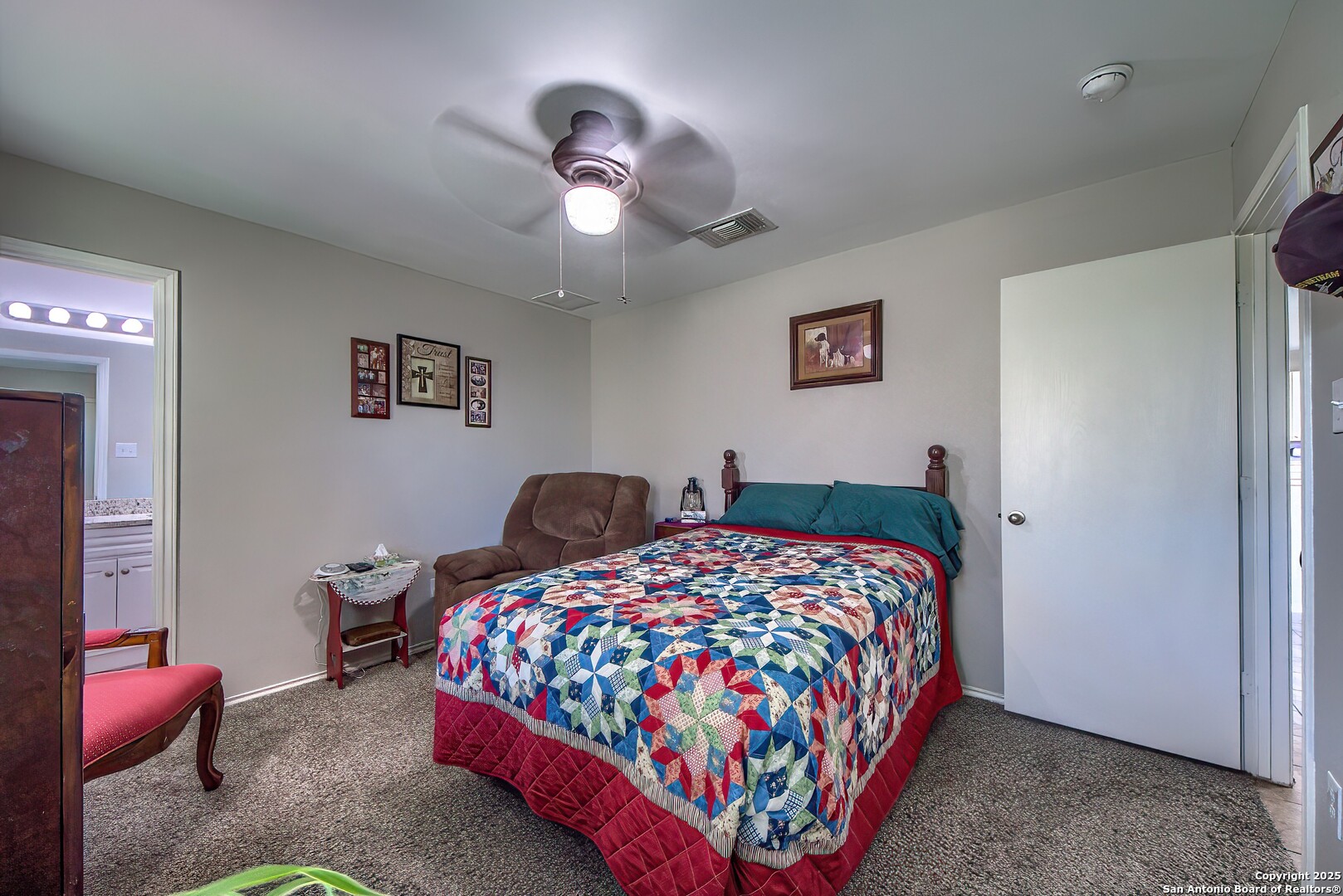 5709 Ping Way Cibolo, TX 78108 - Photo 22 of 28 a bedroom with a bed and a chandelier
