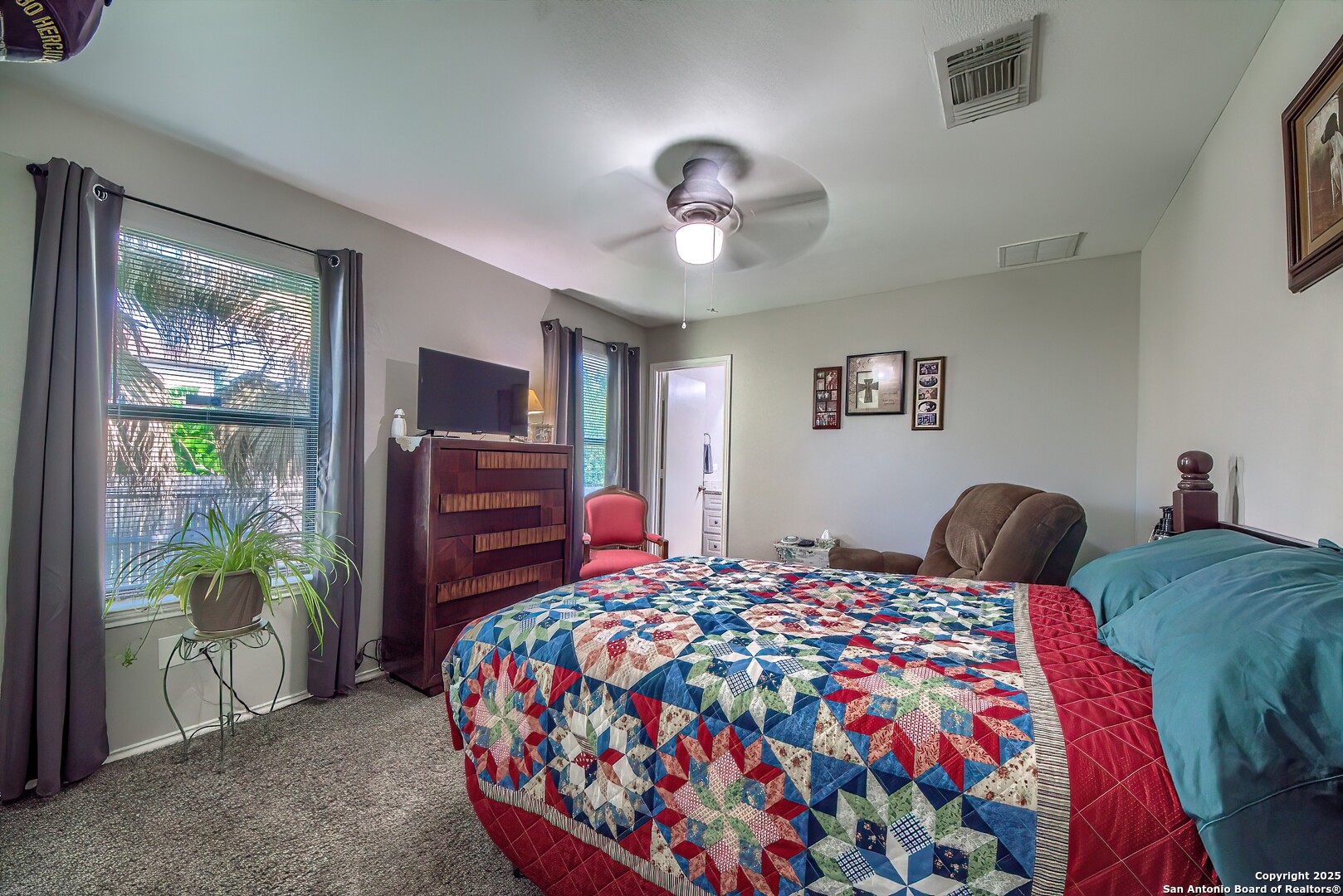 5709 Ping Way Cibolo, TX 78108 - Photo 23 of 28 a bedroom with a bed and a chandelier