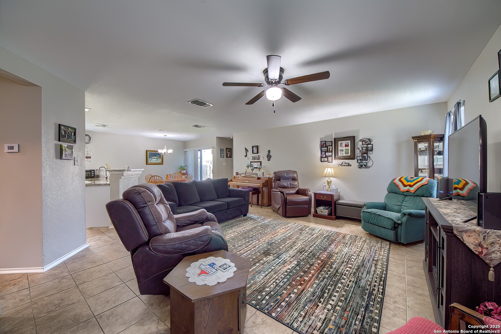 5709 Ping Way Cibolo, TX 78108 - Photo 4 of 28 a living room with furniture a ceiling fan and a rug