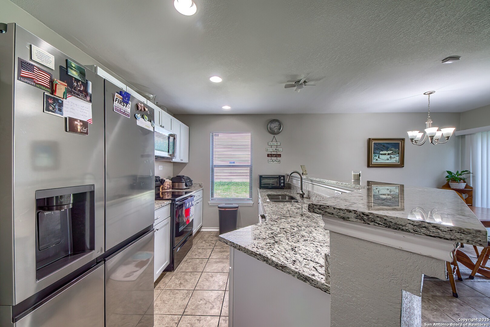 5709 Ping Way Cibolo, TX 78108 - Photo 8 of 28 a kitchen with stainless steel appliances granite countertop a sink and a refrigerator