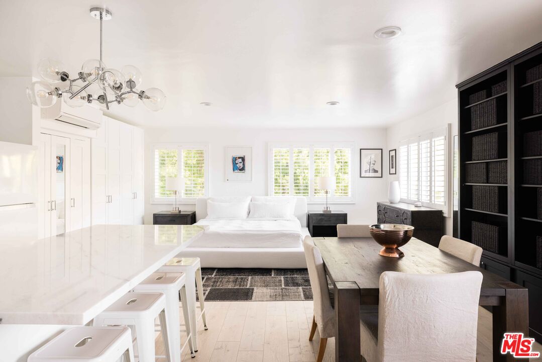 9809 Beeson Drive, Unit C Beverly Hills, CA 90210 - Photo 3 of 7 a living room with furniture a chandelier and a flat screen tv
