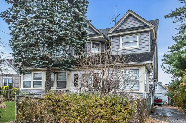 a front view of house with a garden