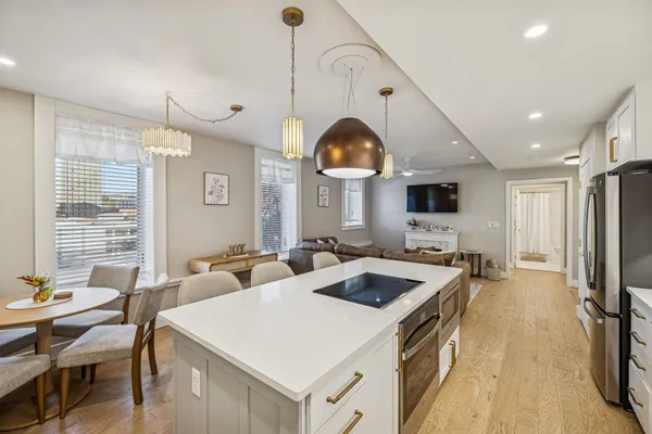 a kitchen with sink stove and cabinets