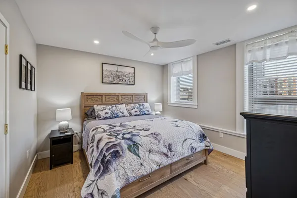 a bedroom with a large bed and a window