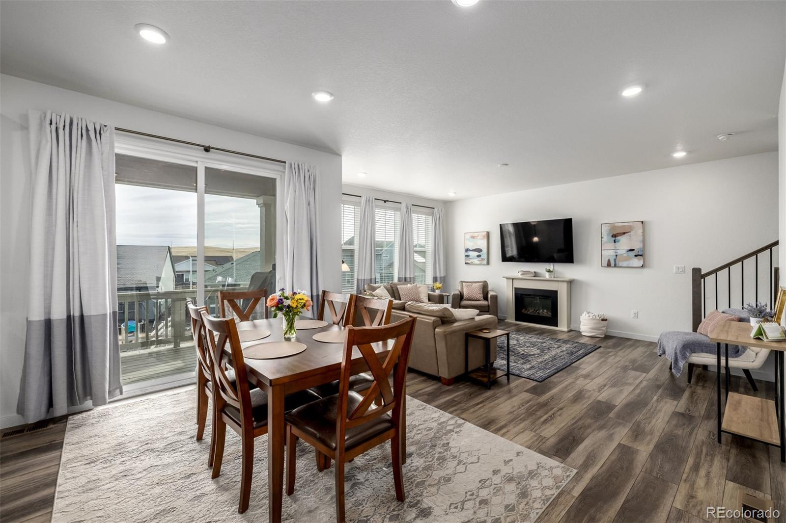 8184 Mt Lincoln Road Littleton, CO 80125 - Photo 12 of 46 a view of a dining room with furniture window and wooden floor