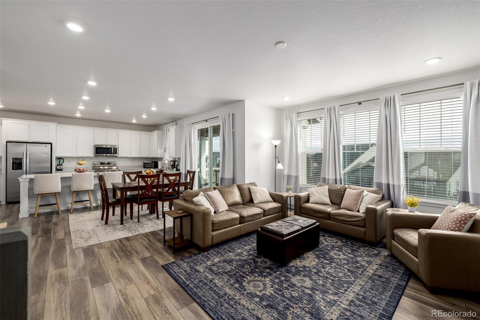 8184 Mt Lincoln Road Littleton, CO 80125 - Photo 14 of 46 a living room with lots of furniture wooden floor and a large window