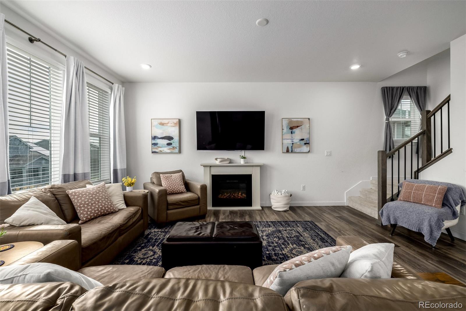 8184 Mt Lincoln Road Littleton, CO 80125 - Photo 16 of 46 a living room with furniture a fireplace and a flat screen tv