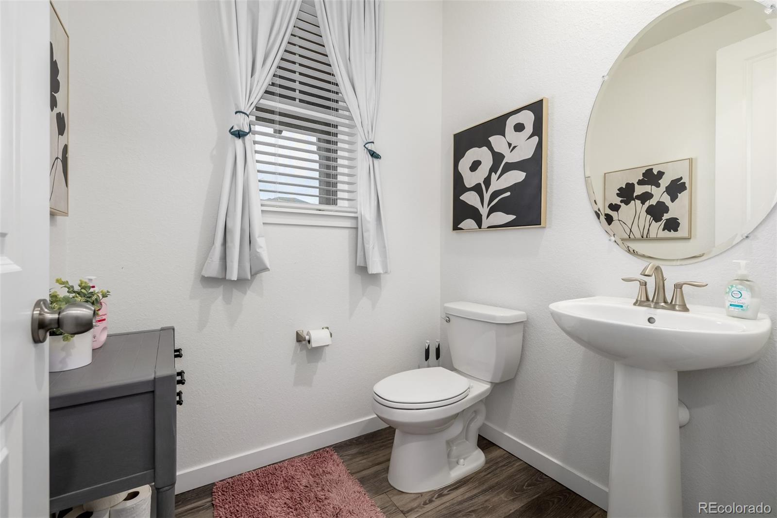 8184 Mt Lincoln Road Littleton, CO 80125 - Photo 18 of 46 a bathroom with a sink toilet and mirror