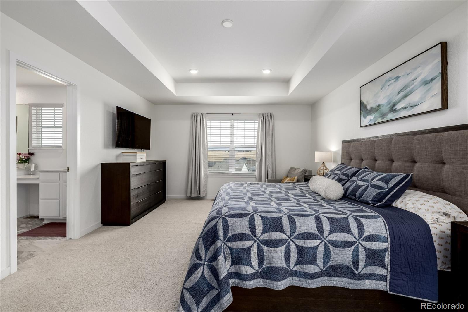 8184 Mt Lincoln Road Littleton, CO 80125 - Photo 21 of 46 a bedroom with a bed and a flat screen tv