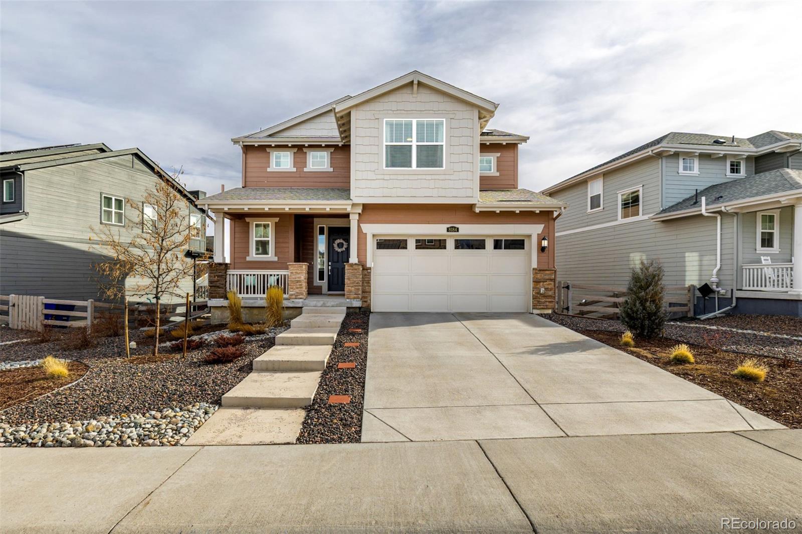 8184 Mt Lincoln Road Littleton, CO 80125 - Photo 3 of 46 a front view of a house with a yard and garage