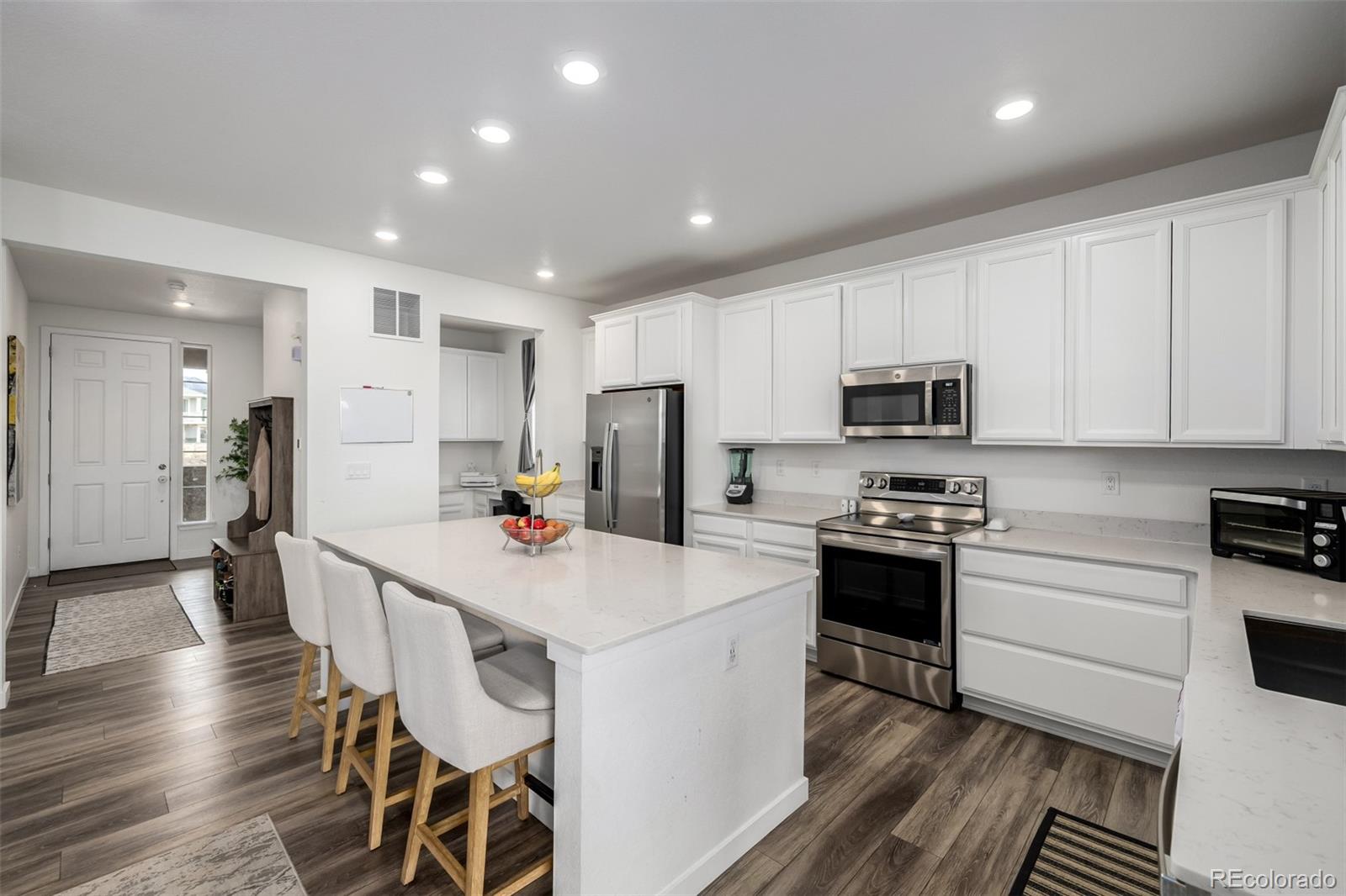 8184 Mt Lincoln Road Littleton, CO 80125 - Photo 6 of 46 a kitchen with stainless steel appliances a stove sink microwave and cabinets