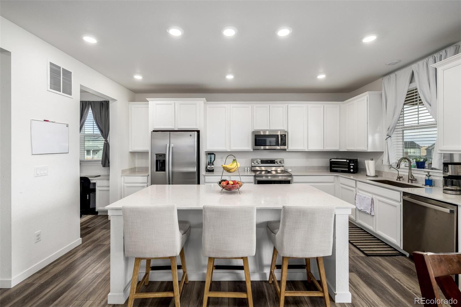 8184 Mt Lincoln Road Littleton, CO 80125 - Photo 10 of 46 a kitchen with stainless steel appliances a refrigerator stove microwave and cabinets