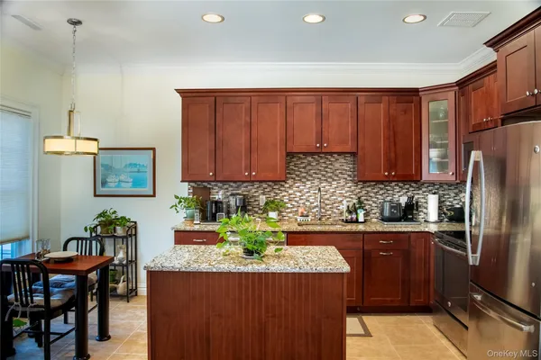 a kitchen with stainless steel appliances granite countertop a refrigerator sink and cabinets