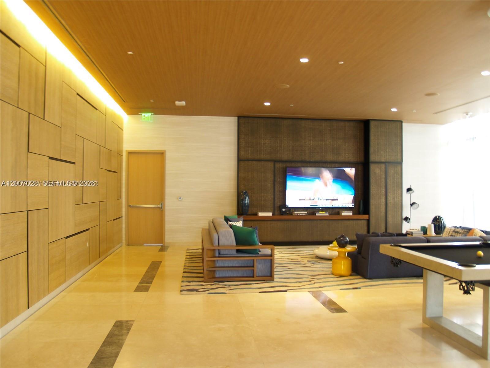 55 Southwest 9th Street, Unit 2502 Miami, FL 33130 - Photo 15 of 27 a living room with a flat screen tv