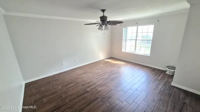 wooden floor in an empty room with a window
