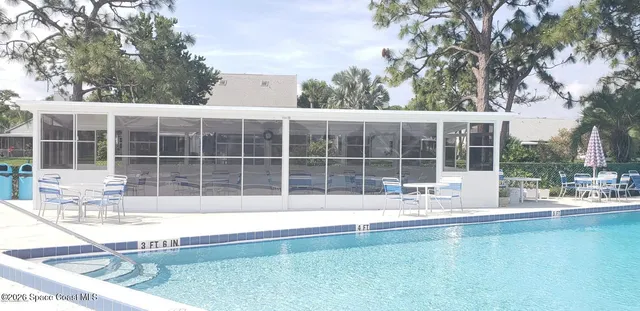 a swimming pool with outdoor seating and yard