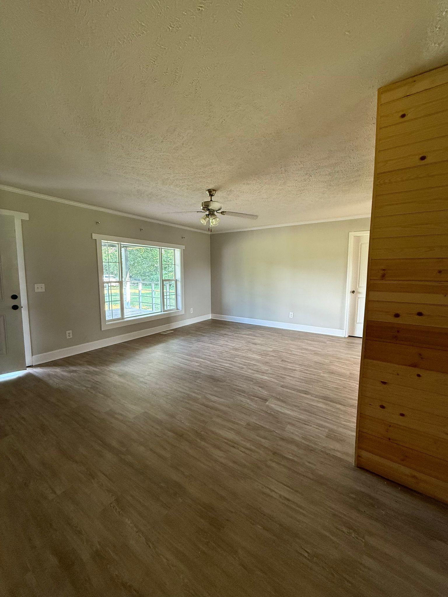 4920 Youngville Road Springfield, TN 37172 - Photo 9 of 54 an empty room with wooden floor cabinet and windows