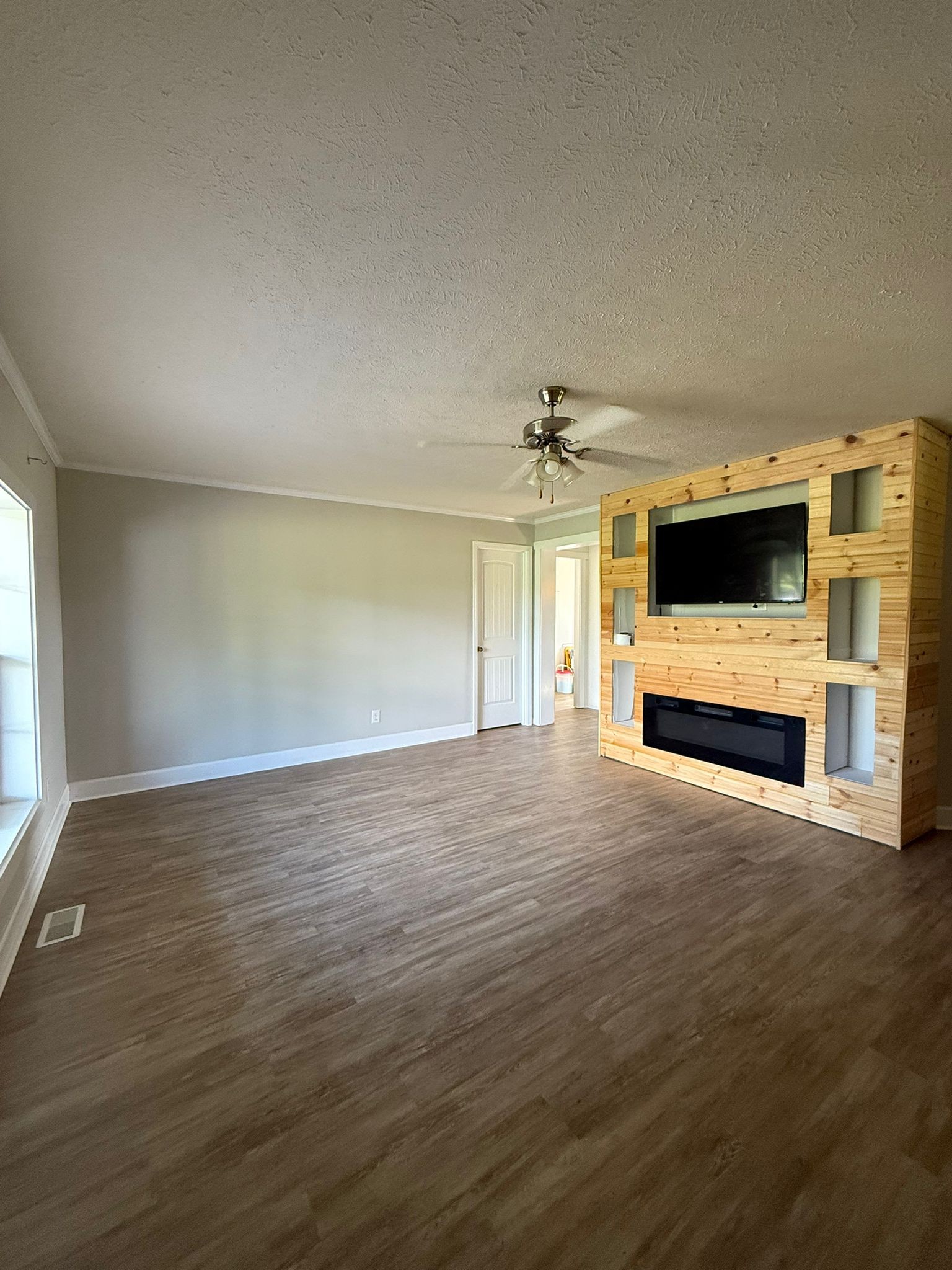 4920 Youngville Road Springfield, TN 37172 - Photo 10 of 54 a view of empty room with wooden floor and fireplace