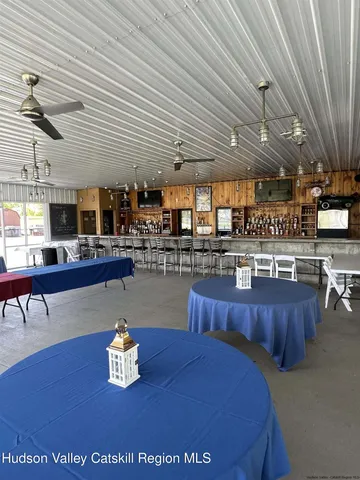 a room with lots of appliances and a wooden floor