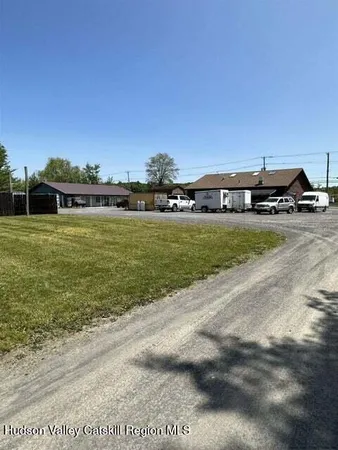 a view of a big yard with a house in the background
